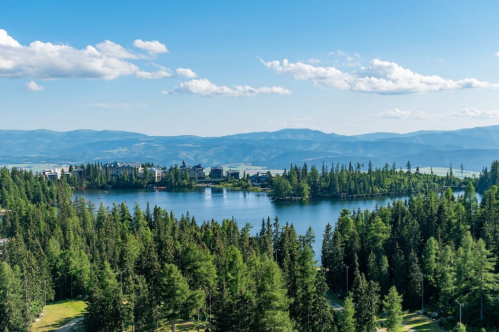 A photo of a mountainous lake with greenery to metaphorically illustrate that data can be stored in a lake